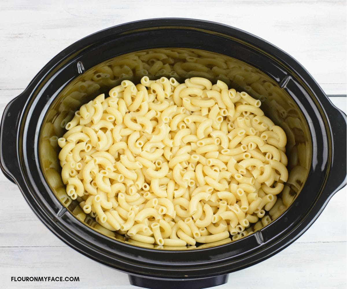Parboiled elbow macaroni in a crock pot.