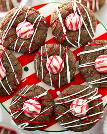 round chocolate peppermint cookies topped with a white and red Hersey's peppermint kiss