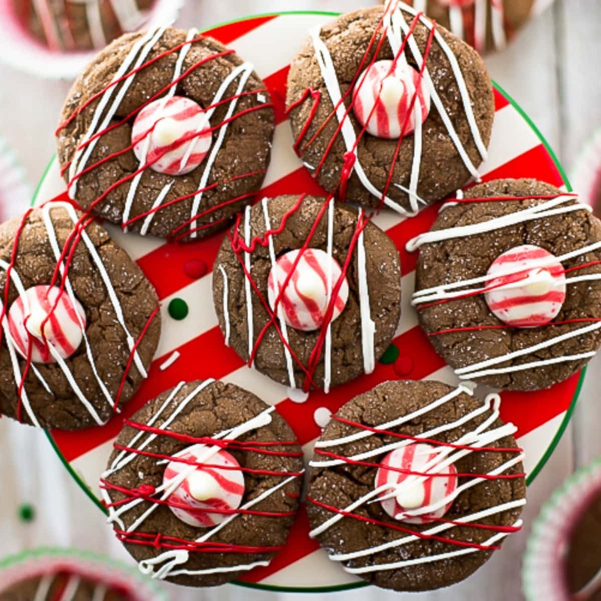 round chocolate peppermint cookies topped with a white and red Hersey's peppermint kiss