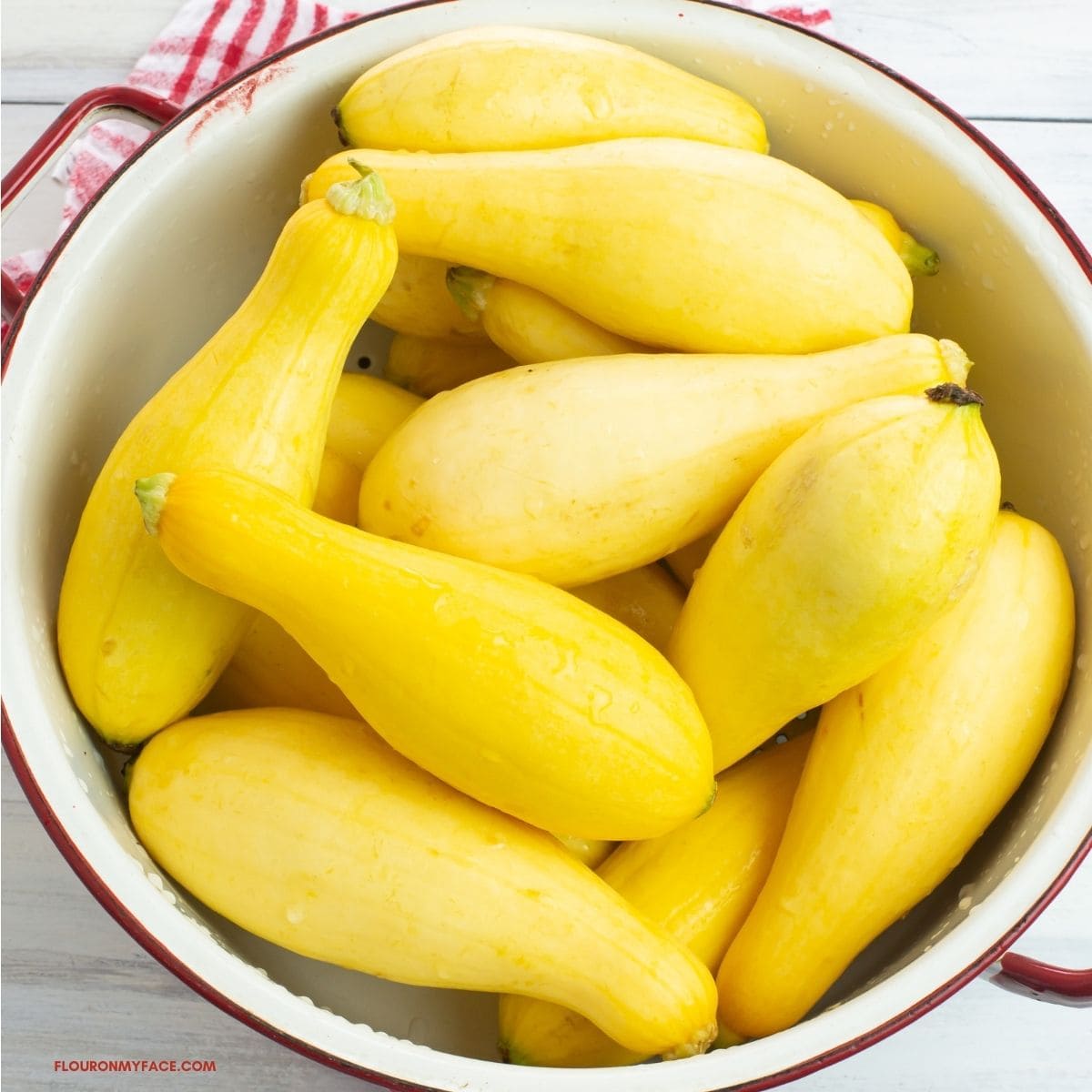 Fresh yellow squash in a colander.