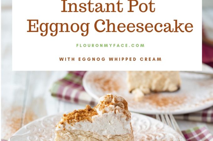 Thick and creamy New York style Instant Pot Eggnog Cheesecake on a white cake stand with two slices of cheesecake on a plates dusted with ground cinnamon.