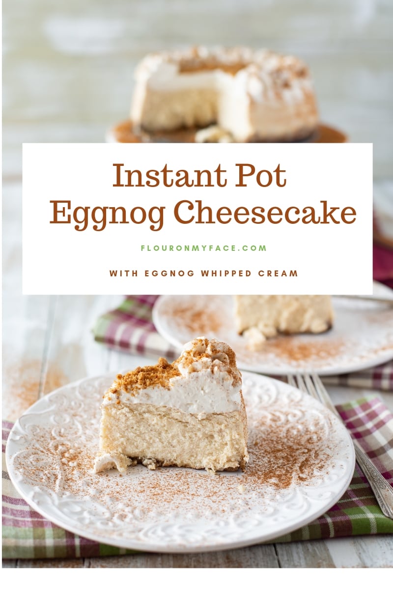 Thick and creamy New York style Instant Pot Eggnog Cheesecake on a white cake stand with two slices of cheesecake on a plates dusted with ground cinnamon.