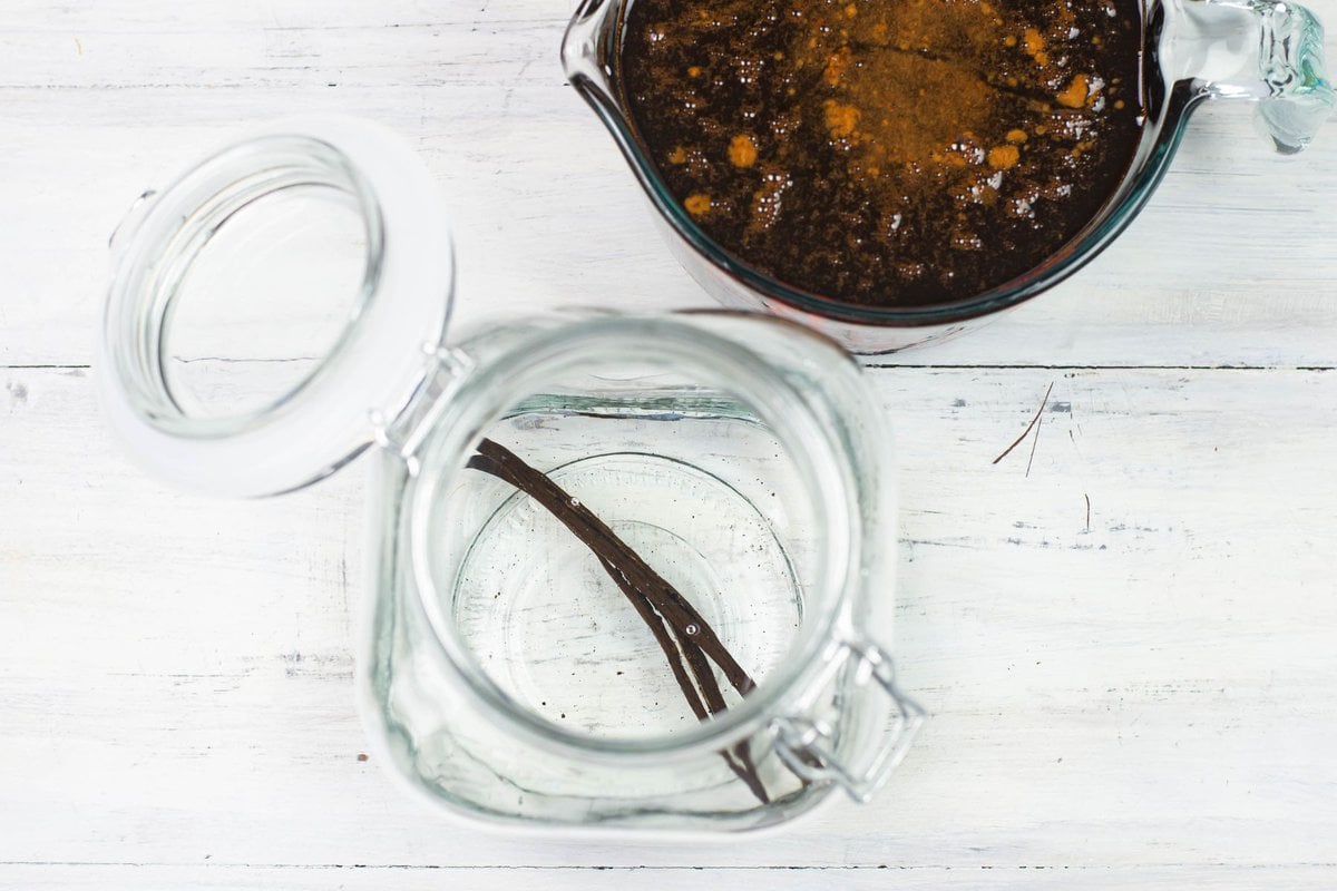 Combining the vodka with the coffee syrup in a jar.