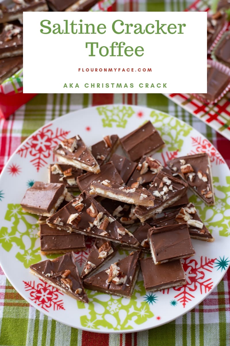 Saltine Cracker Toffee recipe cut into bite size pieces on a red and green Christmas serving plate.