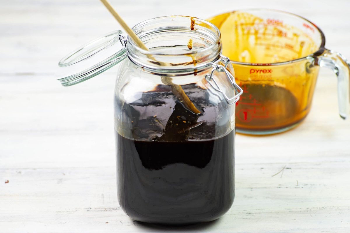 Steeping coffee syrup, vanilla and vodka in a glass jar to make Kahlua.
