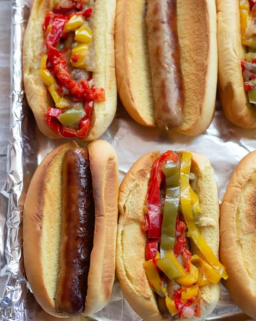 A tray with Instant Pot Brats and Peppers served on Martin's Potato Rolls.