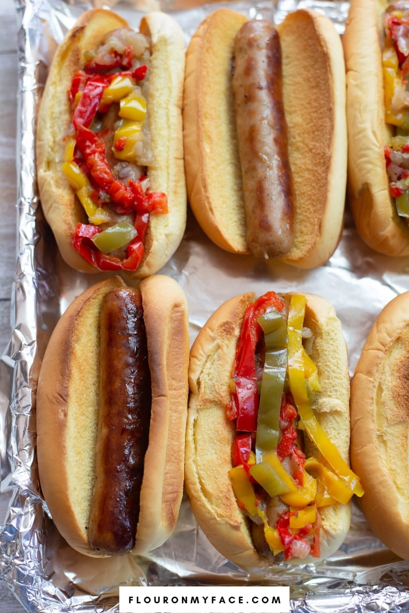 A tray with Instant Pot Brats and Peppers served on Martin's Potato Rolls.