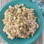 A serving of creamy Tuna Pasta Sald recipe on a vintage Fiesta ware plate