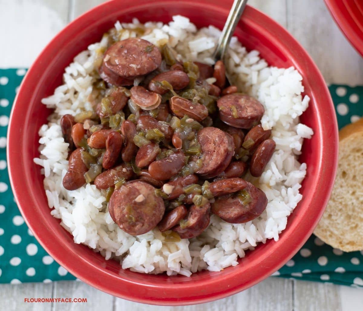 A red bowl filled with a serving or red beans and rice.