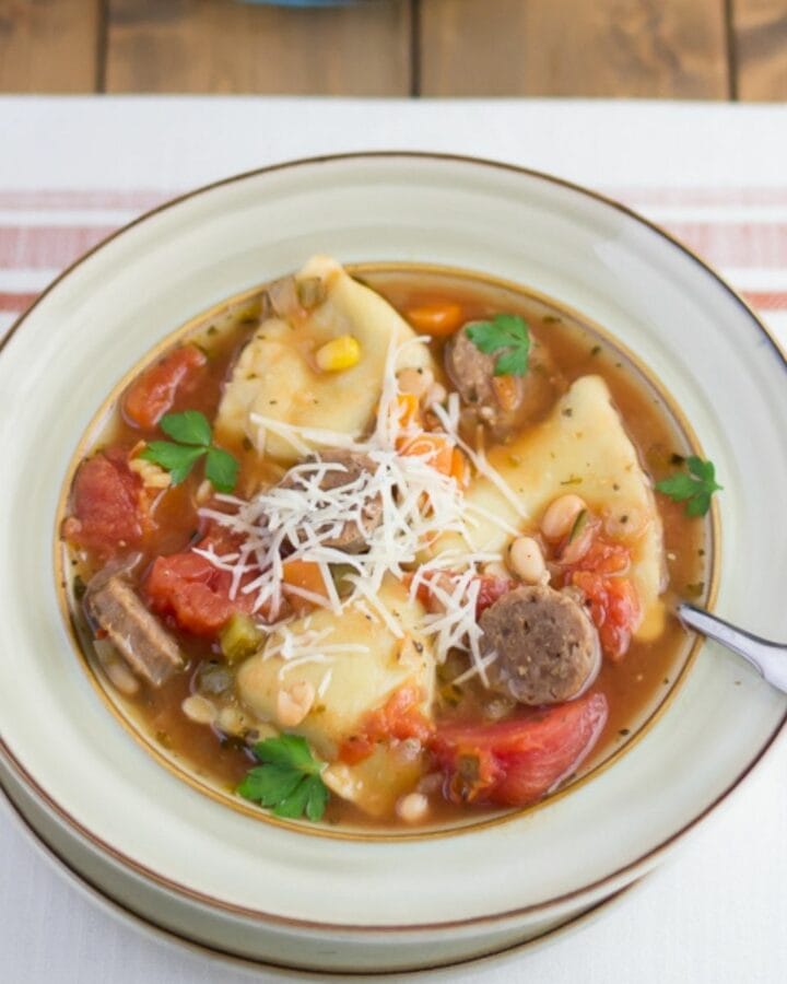 Soup bowl filled with Italian Sausage and cheese ravioli soup.