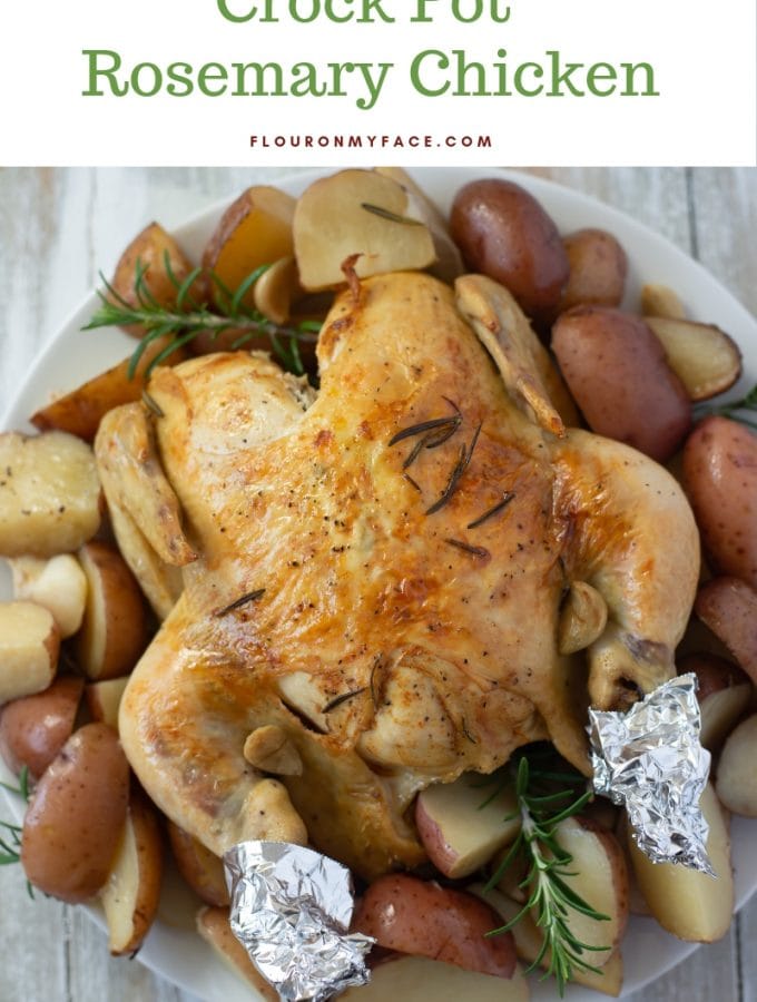 Crock Pot Rosemary Chicken recipe served on a white glass platter with baby red potatoes.