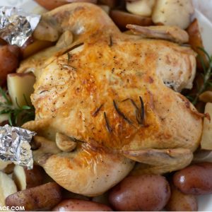 Crock Pot Rosemary Chicken made with a whole chicken served over red potatoes on a platter