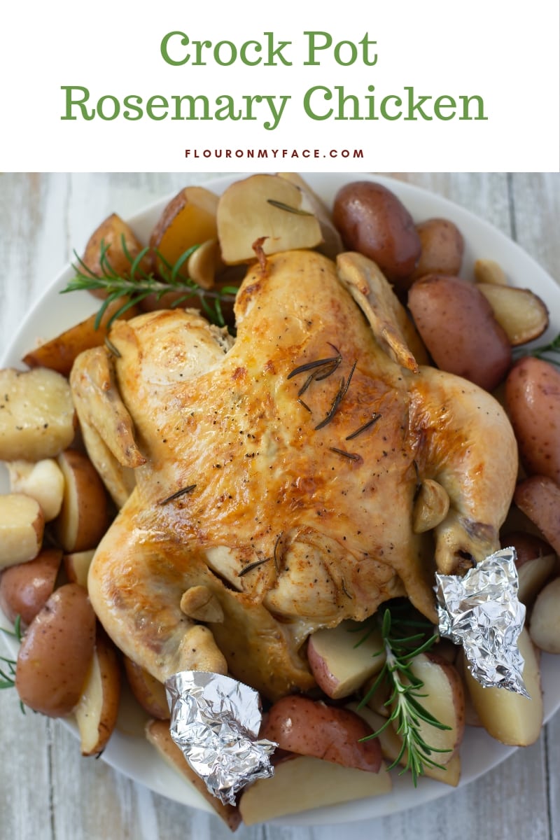 Crock Pot Rosemary Chicken recipe served on a white glass platter with baby red potatoes.