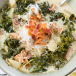 A tan bowl filled with a serving of Crock Pot Zuppa Toscana Soup recipe
