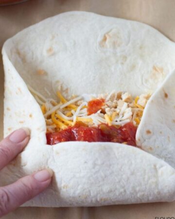 Photo example of how to roll up a breakfast burrito.