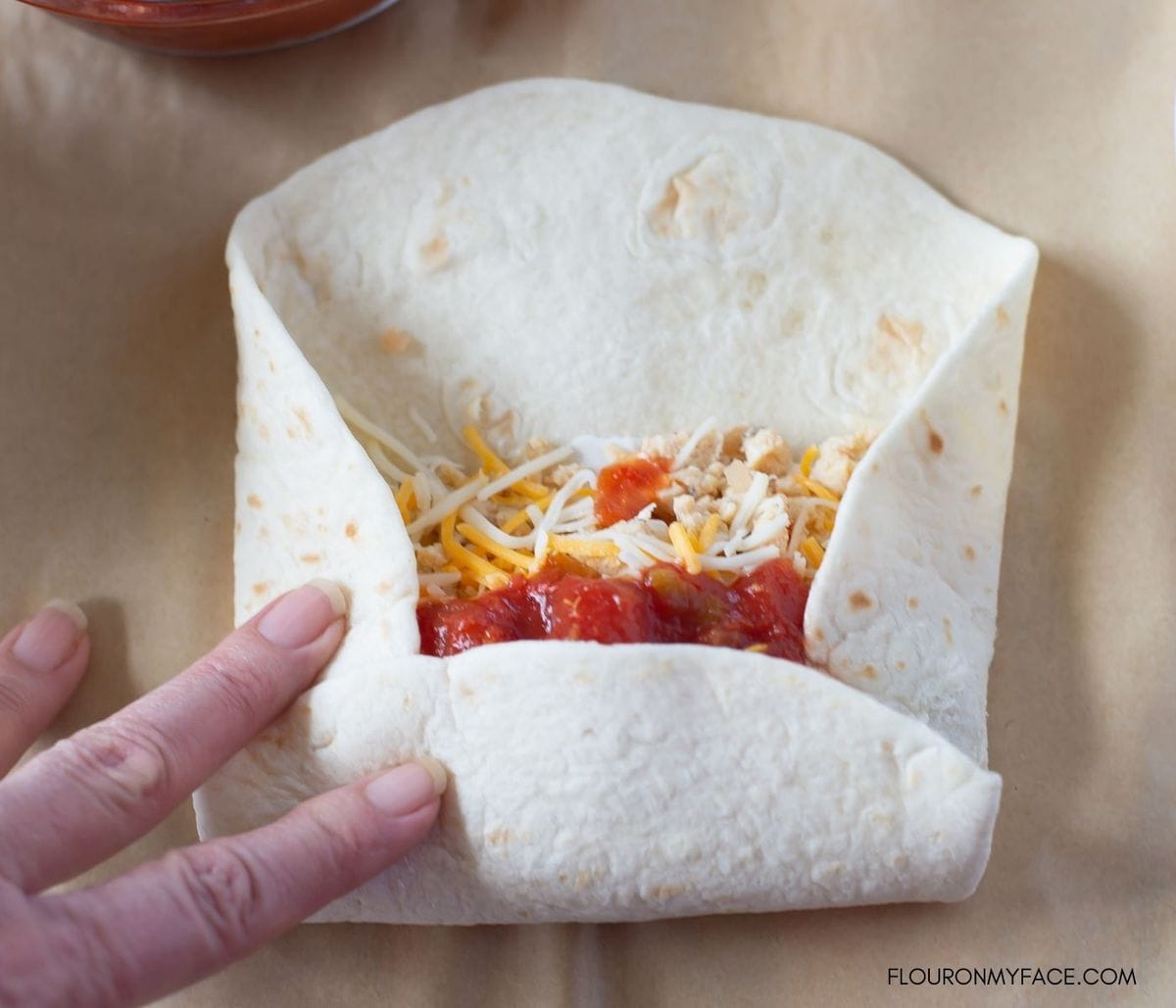 Photo example of how to roll up a breakfast burrito.