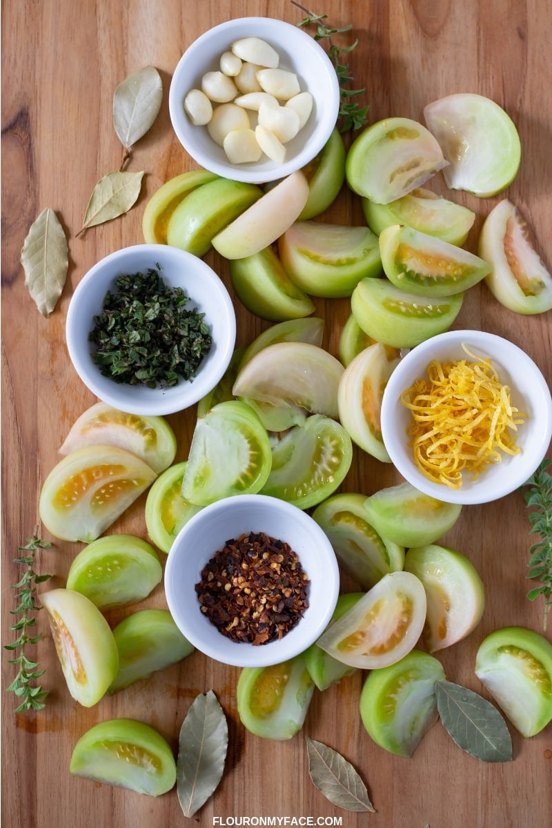 Quick Pickled Green Tomatoes ingredients on a wooden cutting board.