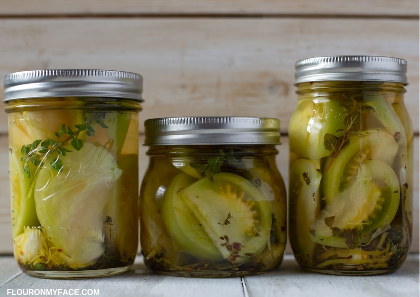Three jars of quick pickled green tomatoes