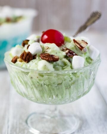 A glass dessert bowl filled with Watergate Salad.