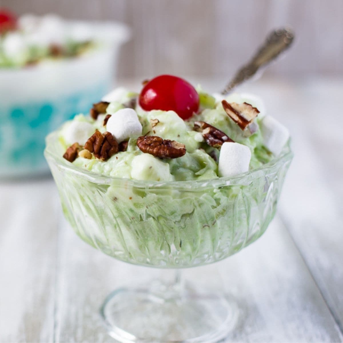 A glass dessert bowl filled with Watergate Salad.