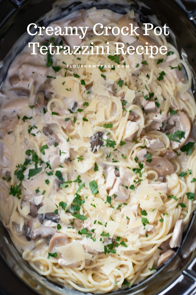 A crock pot filled with the finished creamy Crock Pot Tetrazzini recipe