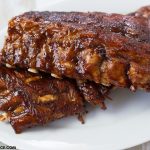 Two racks of baby back ribs on a serving platter after cooking in the Instant Pot