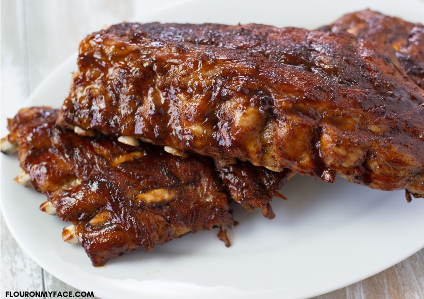 Two racks of baby back ribs on a serving platter after cooking in the Instant Pot