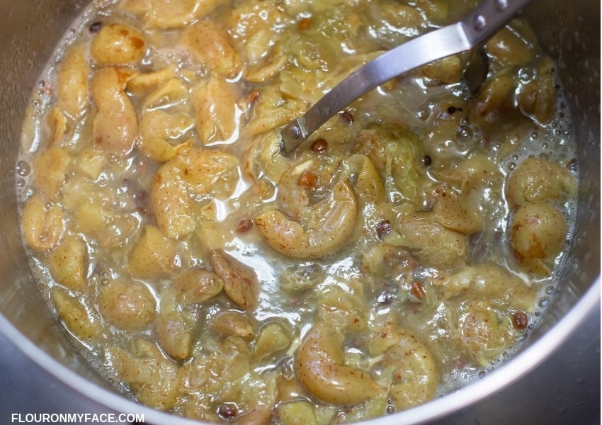 a pot filled with grapes to boil for grape juice to make homemade grape jelly