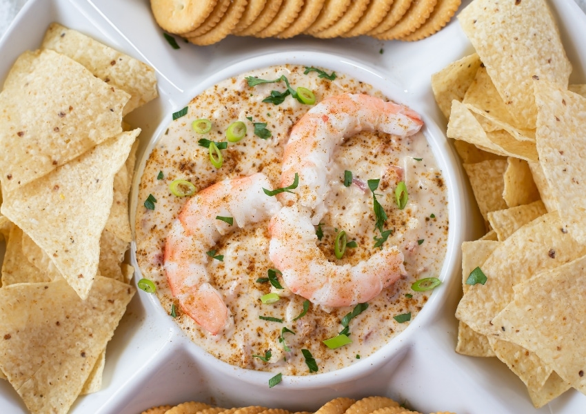 Picture pf Crpck Pot Hot Shrimp Dip that is in a chip and dip serving platter