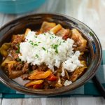 A serving of crock pot Unstuffed Cabbage Rolls with a scoop of white rice mounded on top.