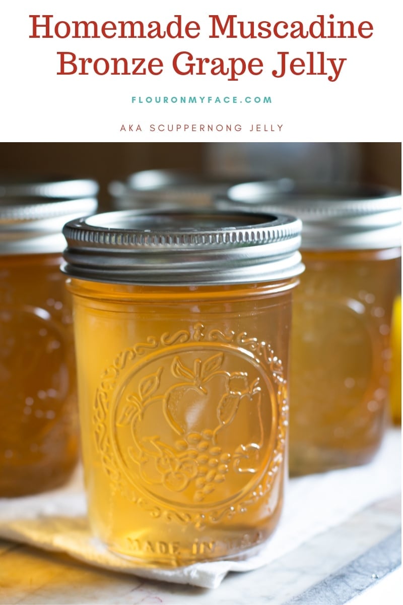 A close up photo of a jar filled with homemade grape jelly.