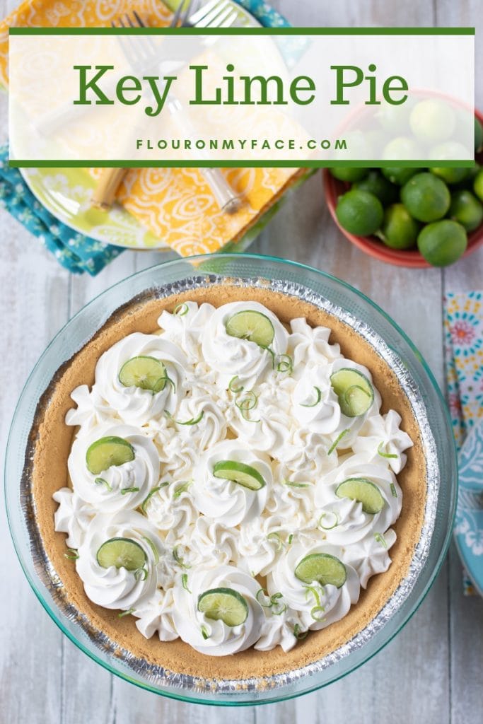 Key Lime Pie topped with whipped cream and garnished with Key lime slices