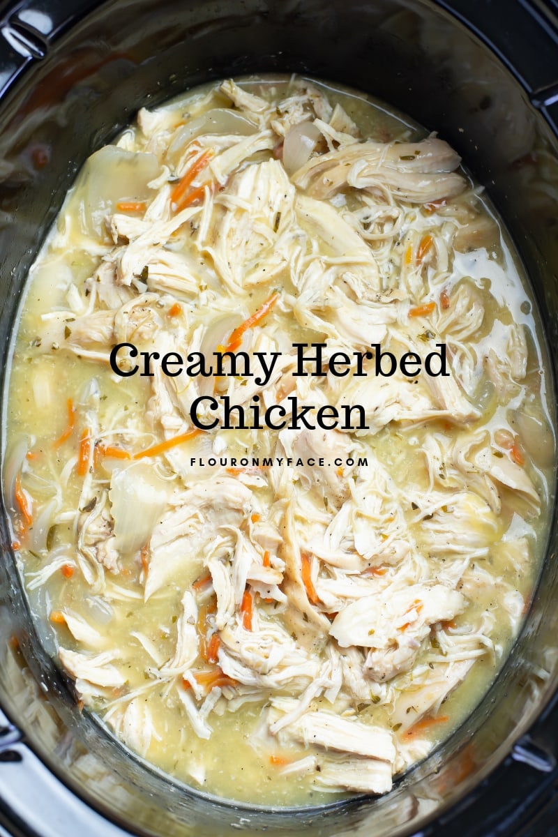 Overhead photo of the finished Crock Pot Creamy Herbed Chicken Recipe with chicken meat shredded.