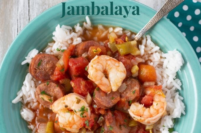 a teal bowl filled with Crock Pot Shrimp and Sausage Jambalaya served over white rice.
