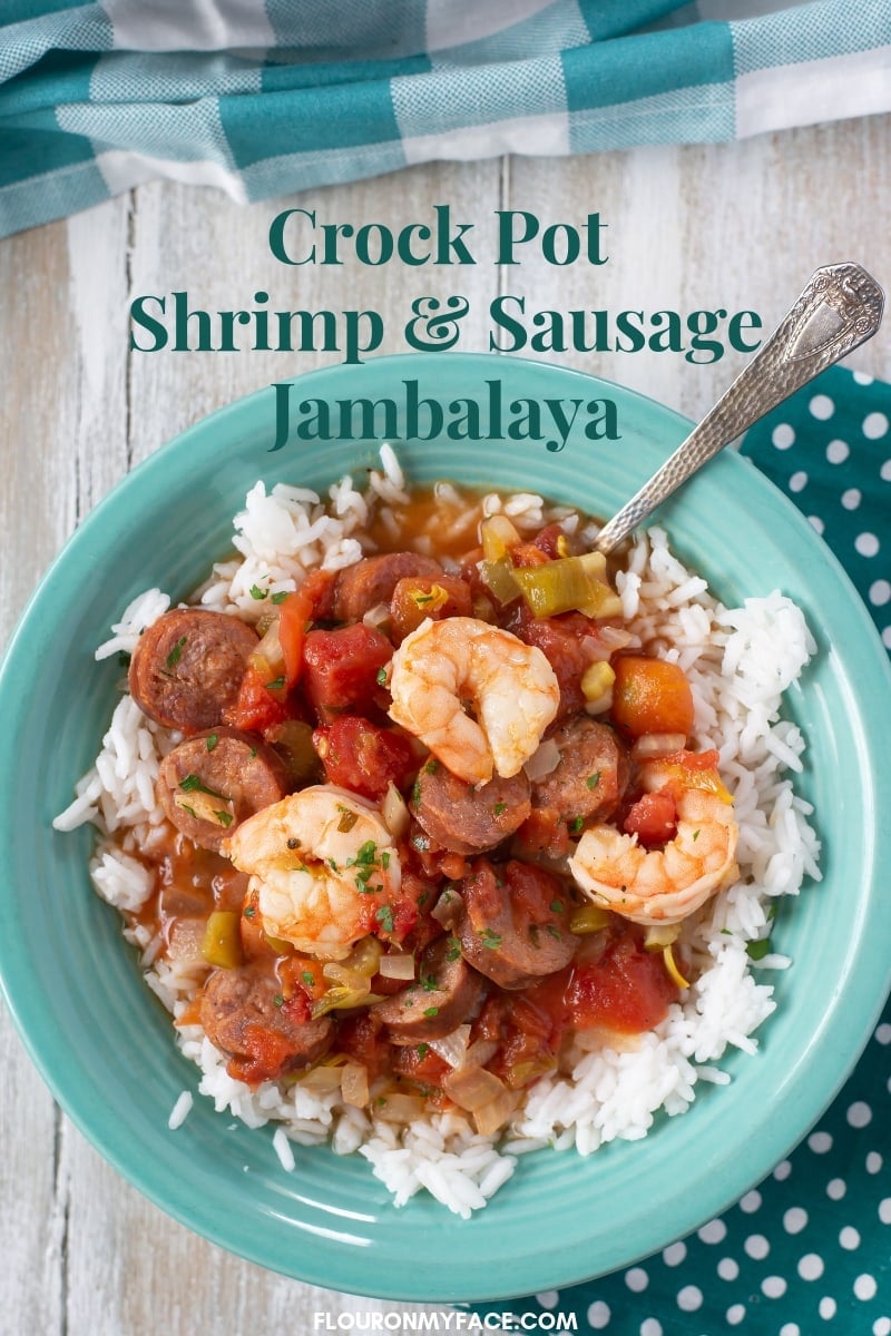 a teal bowl filled with Crock Pot Shrimp and Sausage Jambalaya served over white rice.