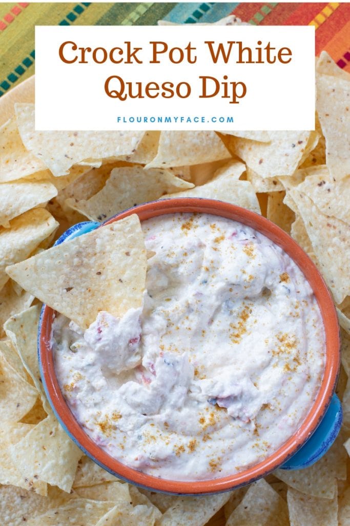 Crock Pot White Queso Dip in a bowl surrounded by tortilla chips