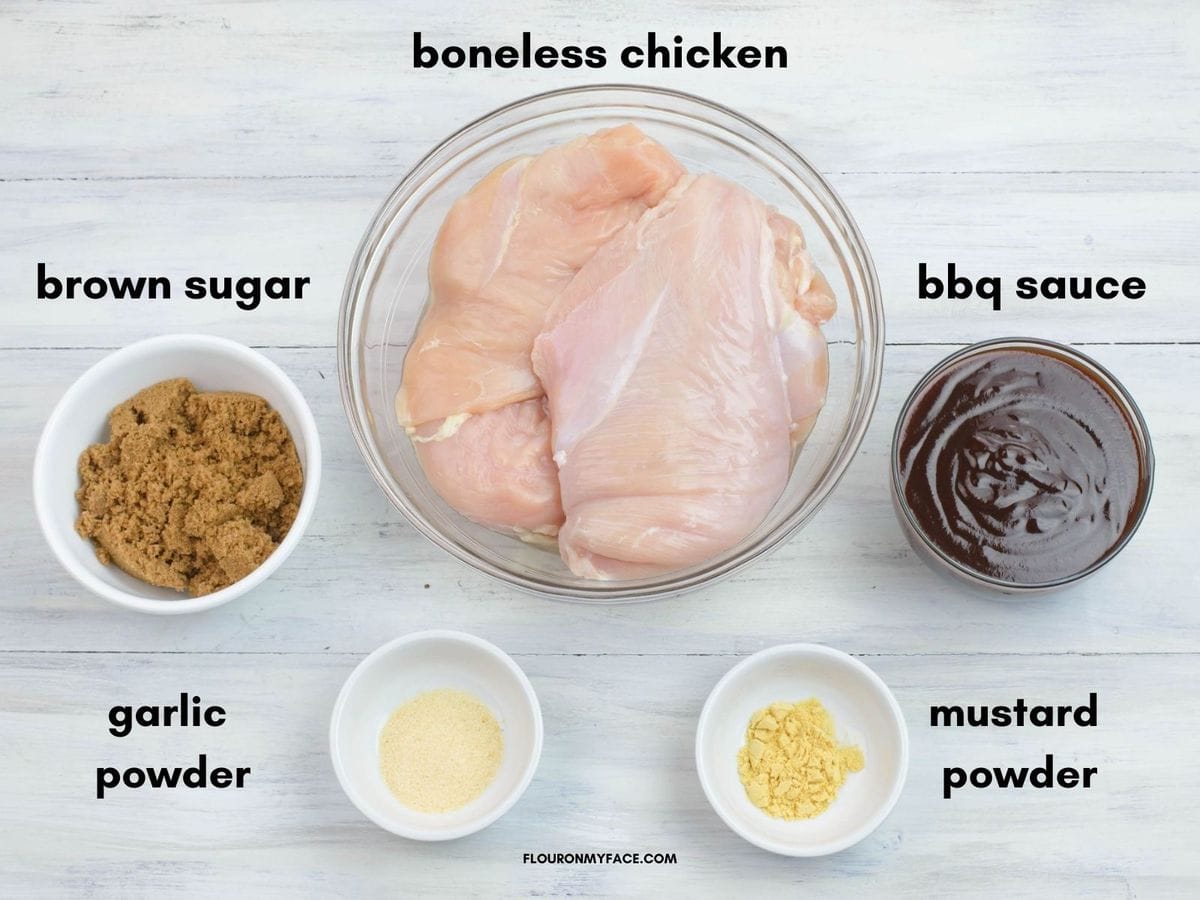 The 5 ingredients in individual bowl needed to make pulled chicken in a crock pot.