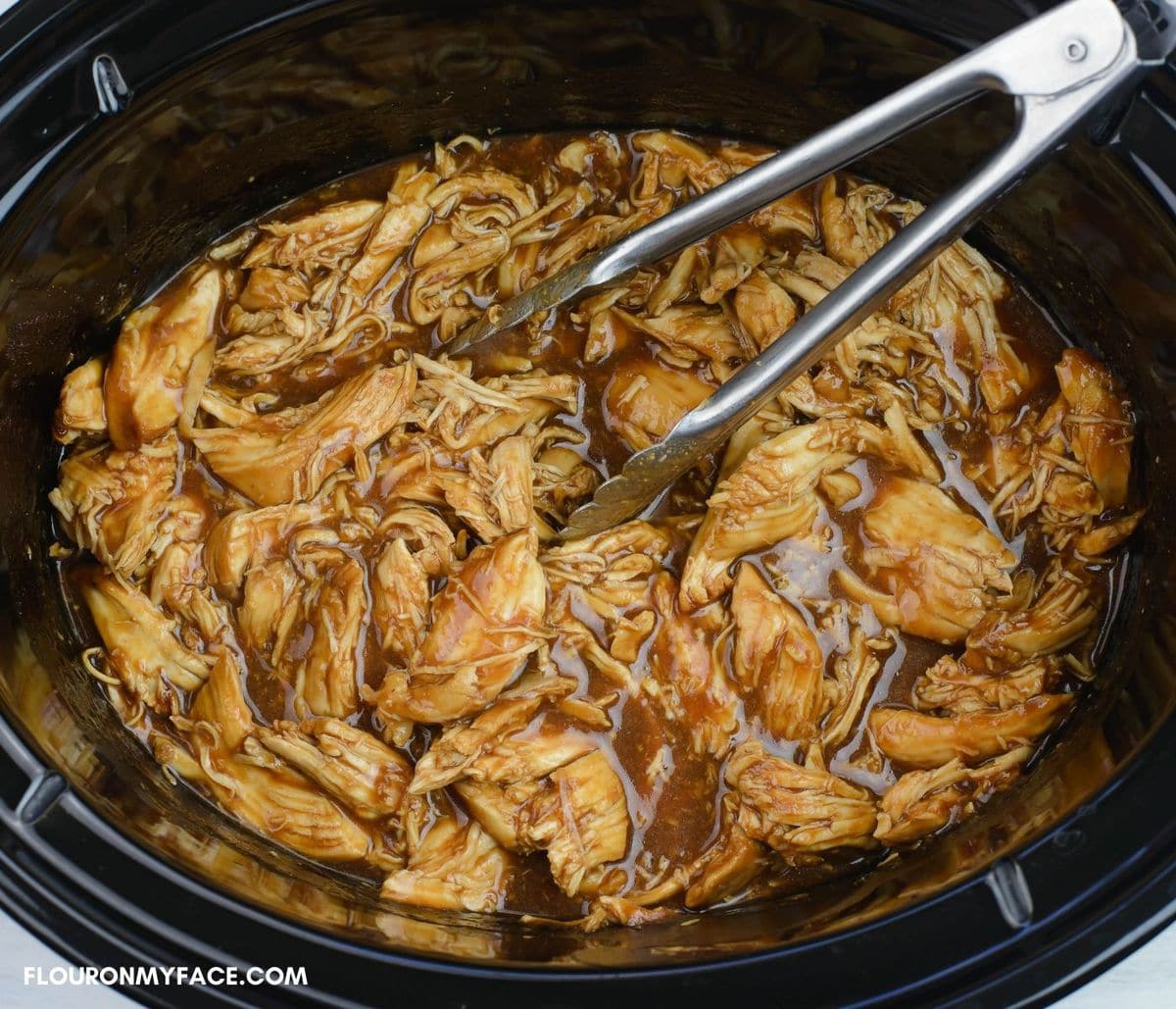 Shredded barbecued chicken in a crock pot.
