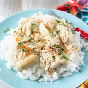 Creamy Herbed Chicken cooked in a crock pot served over white rice.