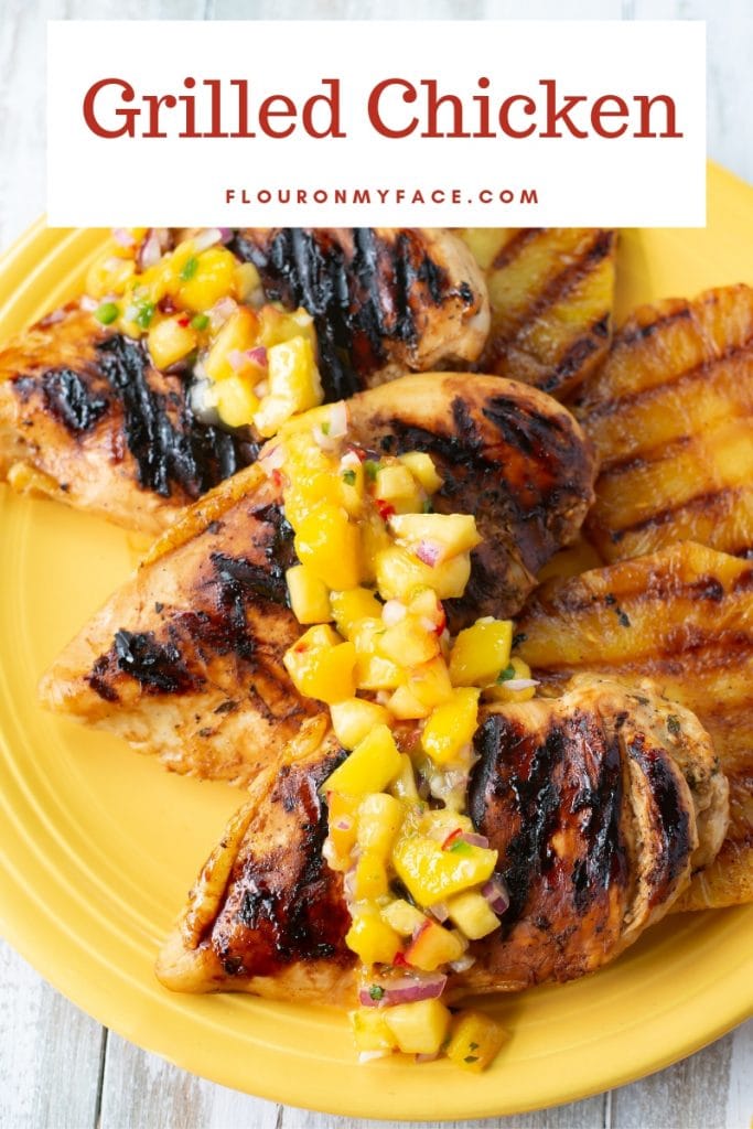 A yellow serving platter with Key Lime Grilled Chicken, grilled pineapple and mango piece salsa.