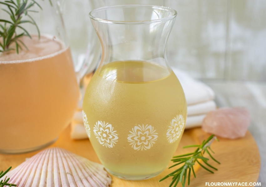 a vintage clear glass decanter filled with homemade pineapple ginger rum 