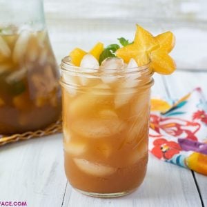 A close up photo of a glass full of freshly made Carambola Iced Tea Cooler