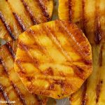 a close up photo of Chili Lime Grilled Pineapple slices on a baking tray