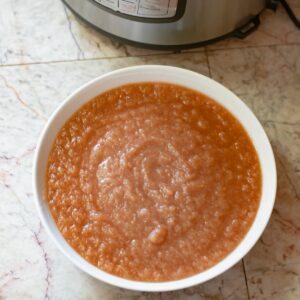 A white bowl filled with homemade instant pot applesauce.