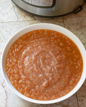 A white bowl filled with homemade instant pot applesauce.