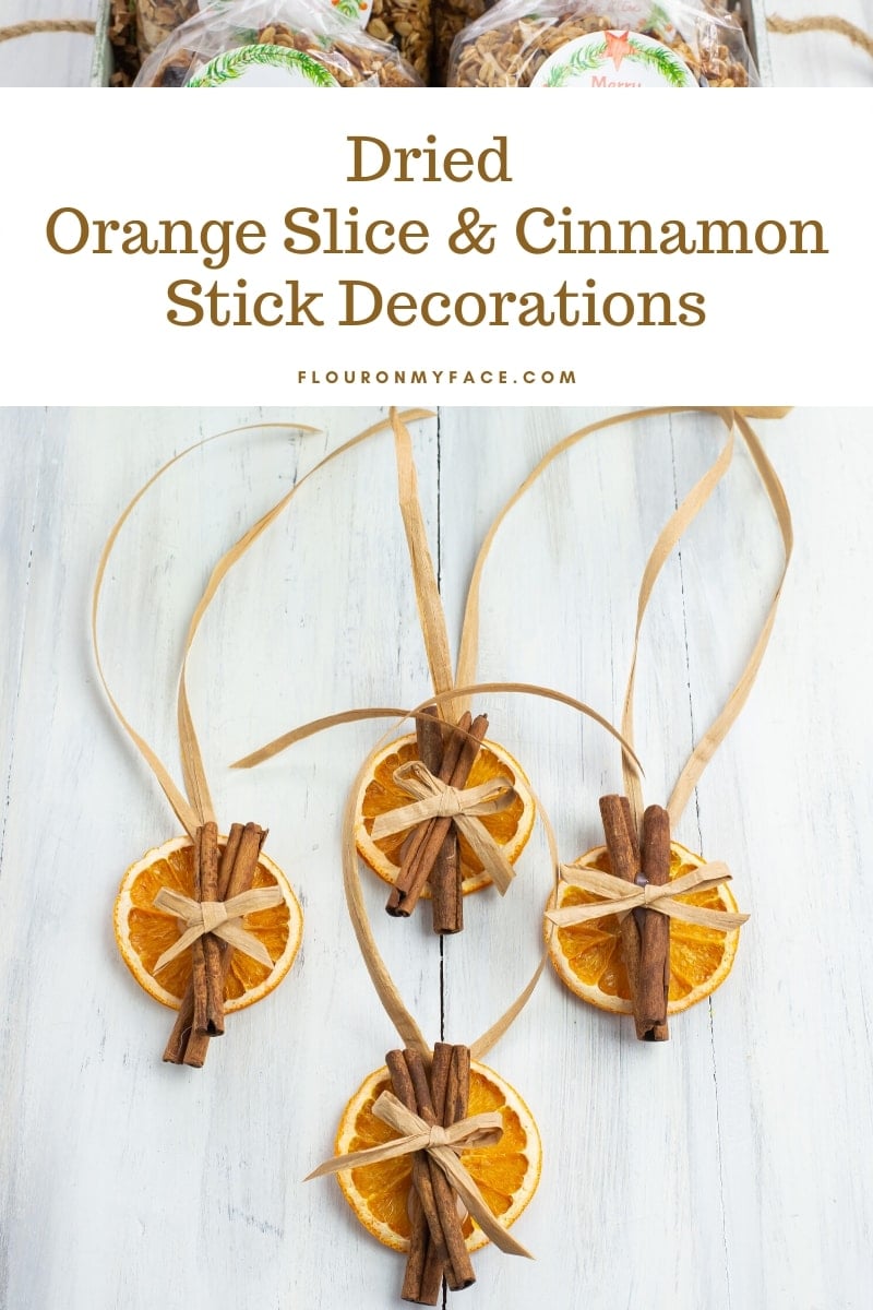 Dried Orange Slices and Cinnamon Stick Decorations with a raffia bow and raffia ribbon ties to hang on holiday gifts.