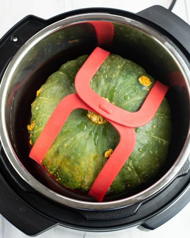 Overhead photo of a Kabocha squash inside the Instant Pot before cooking.