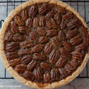 Overhead photo of an uncut freshly baked pecan pie.