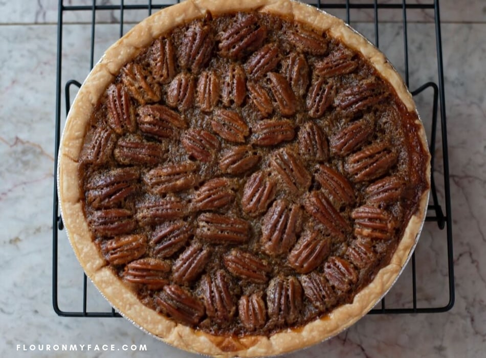 a freshly baked Pecan Pie recipe as it cools on a cooling rack.