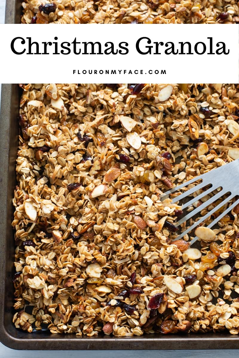 Overhead photo of just baked golden brown homemade Christmas Granola on a baking sheet to cool. Make this easy food gift for the holidays